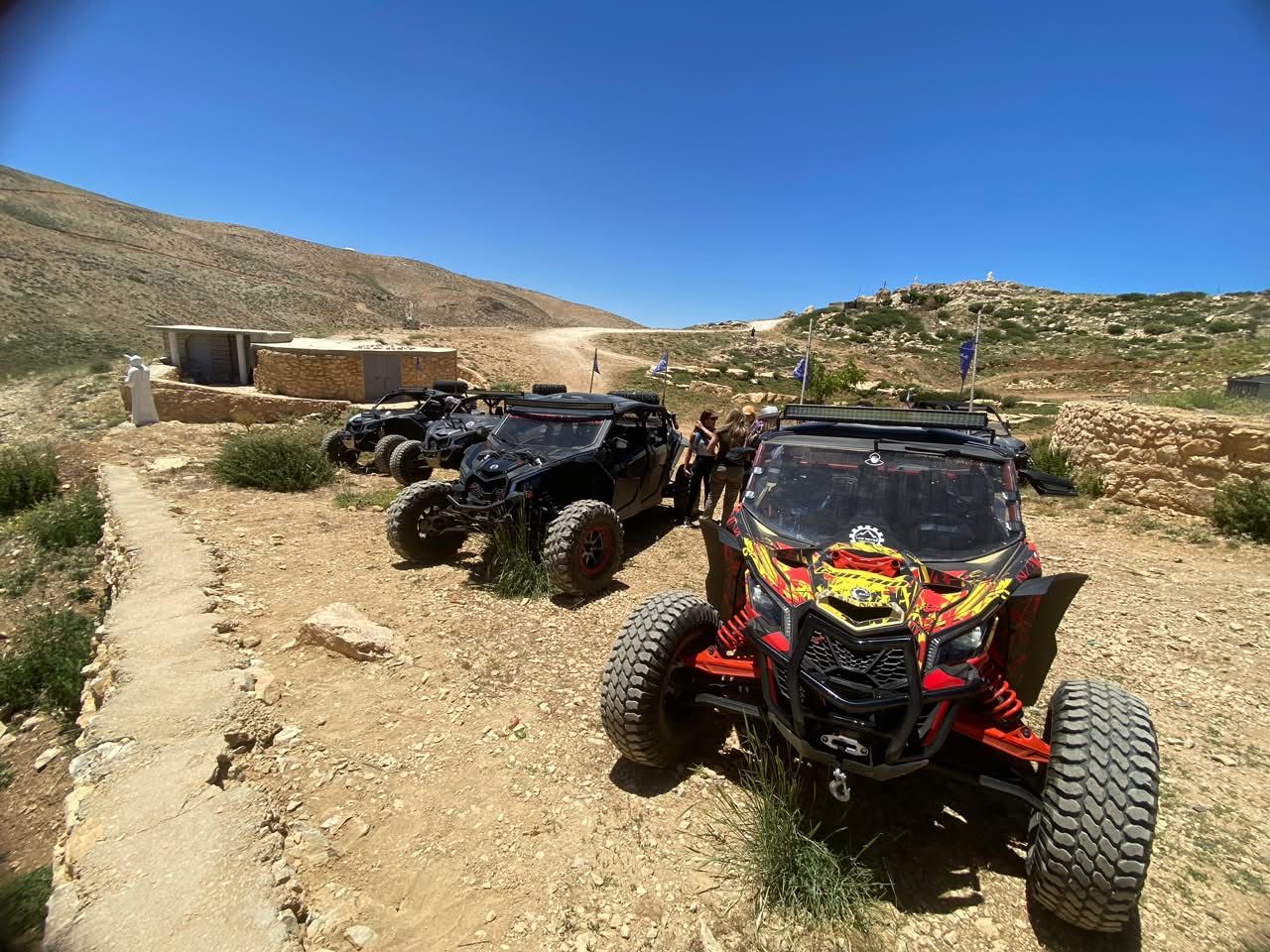 X3 in custom livery parked among rocks